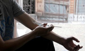 Un consommateur de drogue injecte une substance de type tranquillisant avec un kit d'injection sécuritaire fourni par une ONG en Thaïlande.
