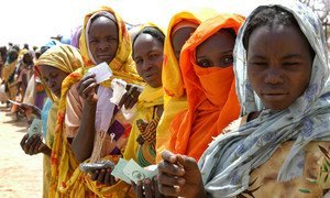 Internally displaced women hold their ration tickets while waiting for a World Food Programme distribution in Mastura, West Darfur, Sudan.