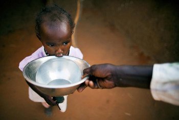 In the Abu Shouk camp for internally displaced persons (IDP) in Darfur, a child gets a drink of water.