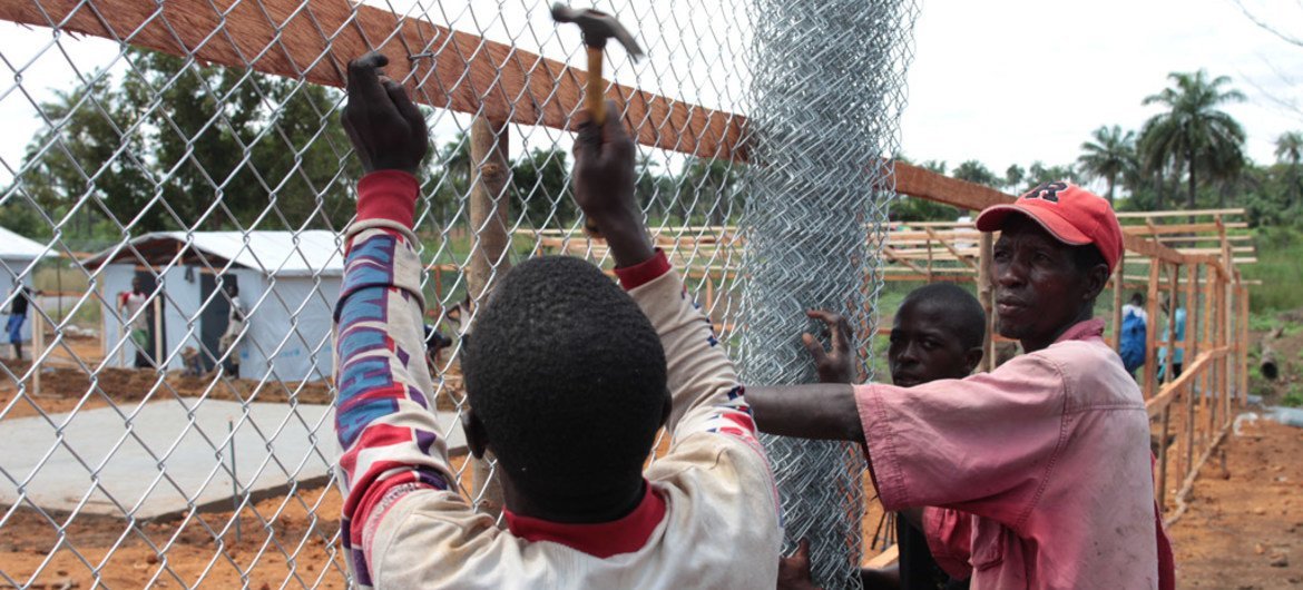 Workers build an enclosure at the Mayagba Ebola community care centre construction site in Bombali District, which is among the areas worst affected by the disease in Sierra Leone.