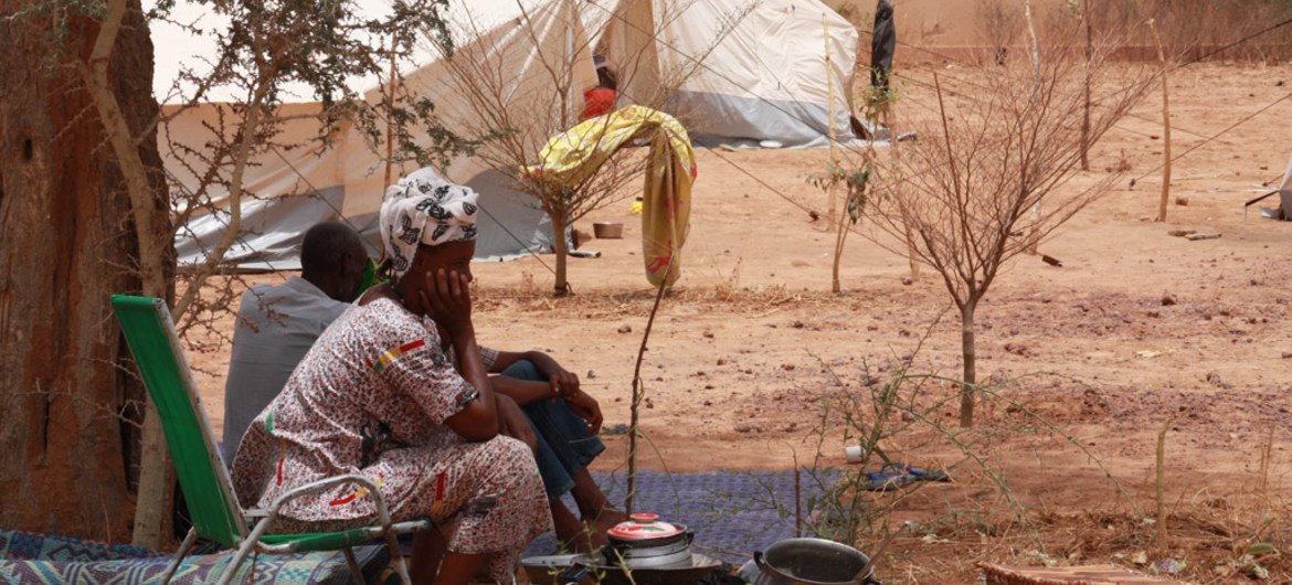 A displaced woman from northern Mali in the Sahel, waits at a temporary shelter near Mopti's main bus station.