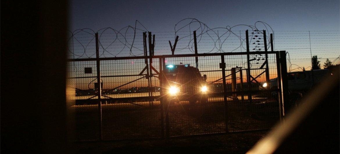 An Israeli Security Forces vehicle lights a gate in the security fence that separates farmers in the Biddu enclave from their land in the Seam Zone, which is the land between the 1949 Armistices Line and the West Bank Barrier.