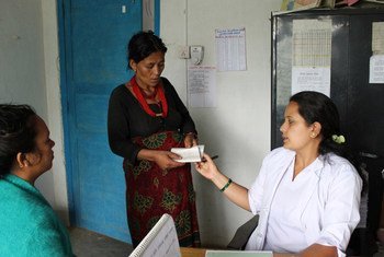 Caption: A skilled birth attendant (midwife) consults with her patient in rural Nepal. World Bank/Aisha Faquir
