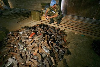 A UN peacekeeper in the Democratic Republic of the Congo (DRC) examines AK-47 magazines stored in a warehouse in Beni after they have been collected in the demobilization process in Matembo, North Kivu.
