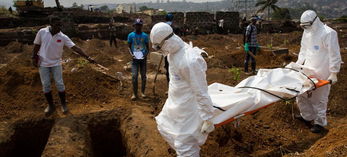 The body of a suspected Ebola case in Sierra Leone is taken by an International Federation of Red Cross (IFRC) team on 24 December to the cemetery where it was buried in a dignified way.