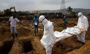 The body of a suspected Ebola case in Sierra Leone is taken by an International Federation of Red Cross (IFRC) team on 24 December to the cemetery where it was buried in a dignified way.
