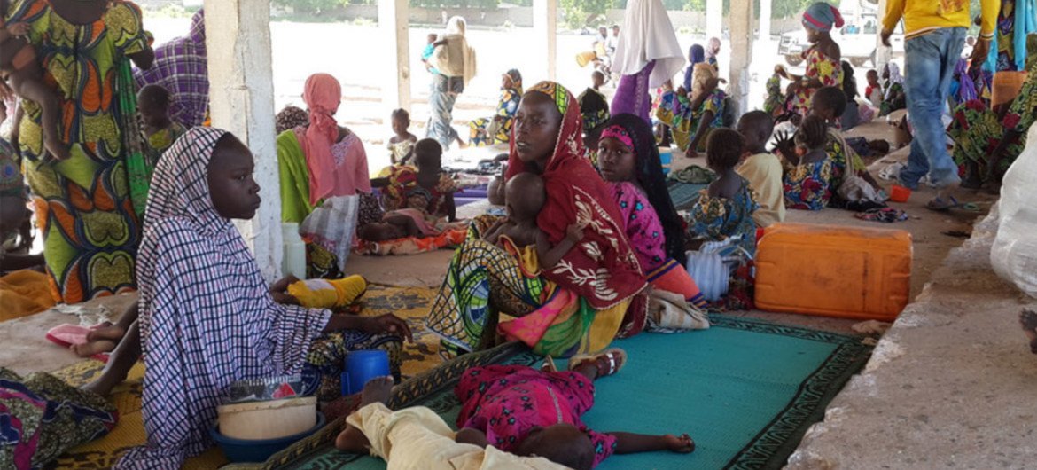 A group of Nigerian refugees rest in the Cameroon town of Mora after fleeing armed Boko Haram attacks.