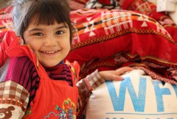 A displaced child in Southern Iraq with UN World Food Programme (WFP) food.
