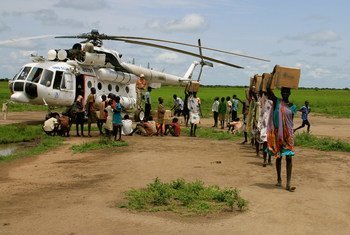 Des femmes transportent de la nourriture livrée par hélicoptère en février 2015 à Kiech Kon, dans l'Etat du Haut-Nil, au Soudan du Sud. Photo UNICEF/Mike Pflanz
