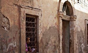 A girl looks out of her house window in Benghazi, Libya.