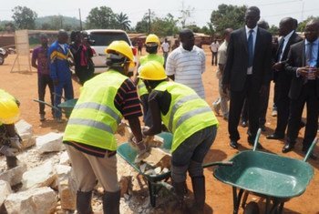 Head of the Africa bureau at the UN Development Programme (UNDP) Abdoulaye Mar Dieye (3rd right) observes young people participating in the construction of their cultural and sports centre funded by UNDP in Bangui, Central African Republic (CAR).