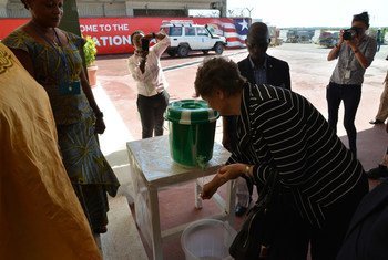 UN Development Program (UNDP) Administrator Helen Clark washes her hands on arrival in Ebola-affected Monrovia, Liberia.