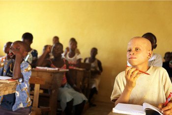 An Albino student (right) attends school in Niambly, near Duekoue, Côte d’Ivoire.