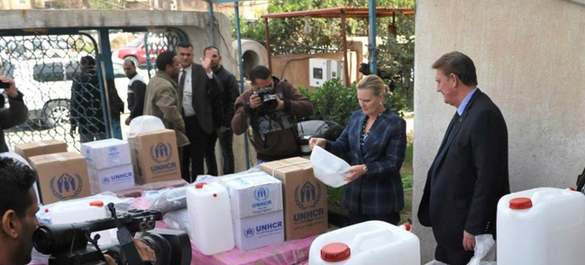 Deputy Special Representative, Lise Grande (second right), and Neill Wright (right), the UN refugee agency (UNHCR) representative in Iraq, examine humanitarian aid for families recently displaced from Al Baghdadi district in the western province of Anbar.