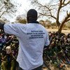 A worker from the South Sudan National Disarmament, Demobilization and Reintegration Commission addresses a group of children undergoing release from the SSDA Cobra Faction armed group, in Pibor, Jonglei State, in February 2015.