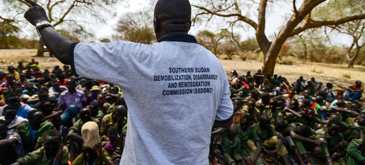 A worker from the South Sudan National Disarmament, Demobilization and Reintegration Commission addresses a group of children undergoing release from the SSDA Cobra Faction armed group, in Pibor, Jonglei State, in February 2015.