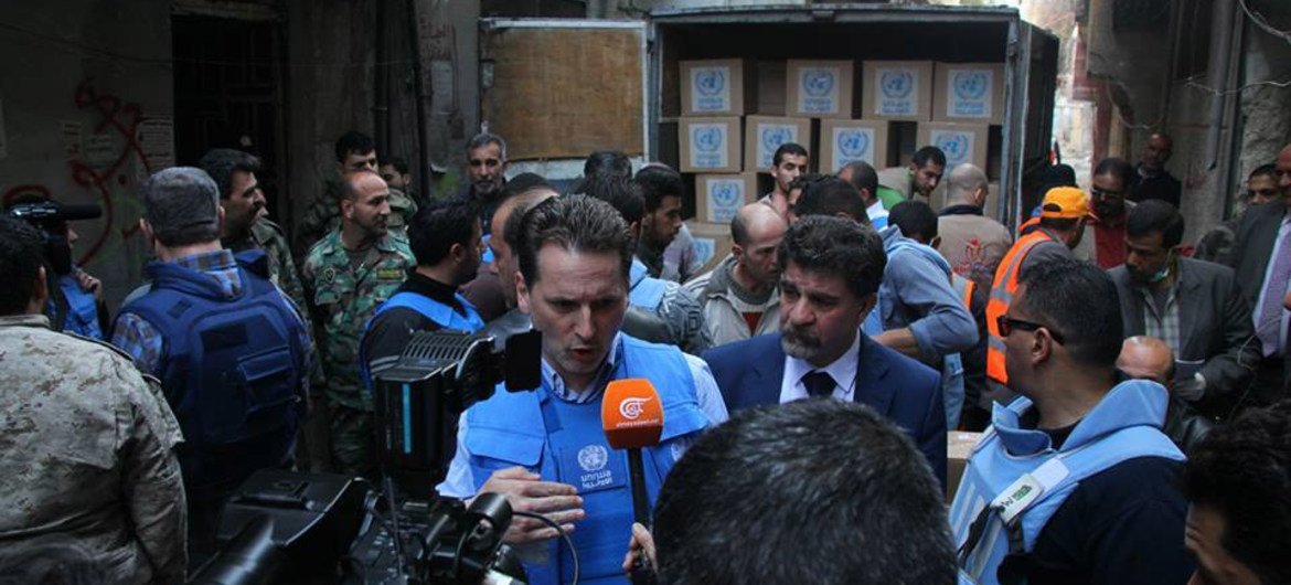UNRWA Commissioner-General Pierre Krähenbühl (centre) speaks to the press during a visit to Yarmouk Syria.