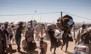 Syrian Kurdish refugees cross into Turkey from Syria near the northern town of Kobane in 2014.