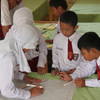 School children in Aceh, Indonesia, work on a risk map as part of community awareness plans to reduce disasters.