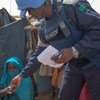 A UNAMID peacekeeper interacts with a woman during a daily patrol aimed at protecting newly-displaced persons at the Zam Zam camp near El Fasher, North Darfur.