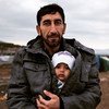 Refugiado sirio en Iraq con su bebé. Foto de archivo: ACNUR/N. Colt