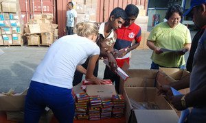 Volunteers pack school bags at UNICEF's Pacific regional warehouse in Suva, Fiji to be dispatched to Cyclone Pam affected areas.