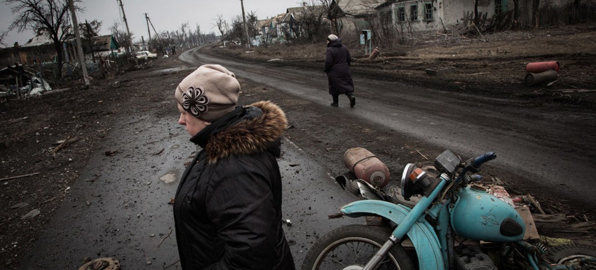Residents walk along the main road of Nikishino village in eastern Ukraine.