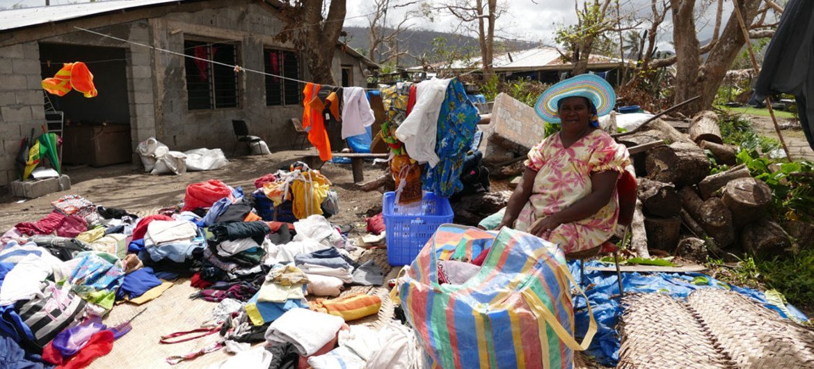 Helen Manvoi sorts through  damaged clothing after Cyclone Pam destroyed the roof of her house in Port vila, Vanuatu.