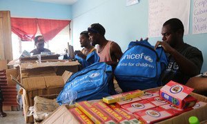 UNICEF staff and community volunteers in Port Vila, Vanuatu pack school kits with essential school supplies for children who lost everything in Cyclone Pam.