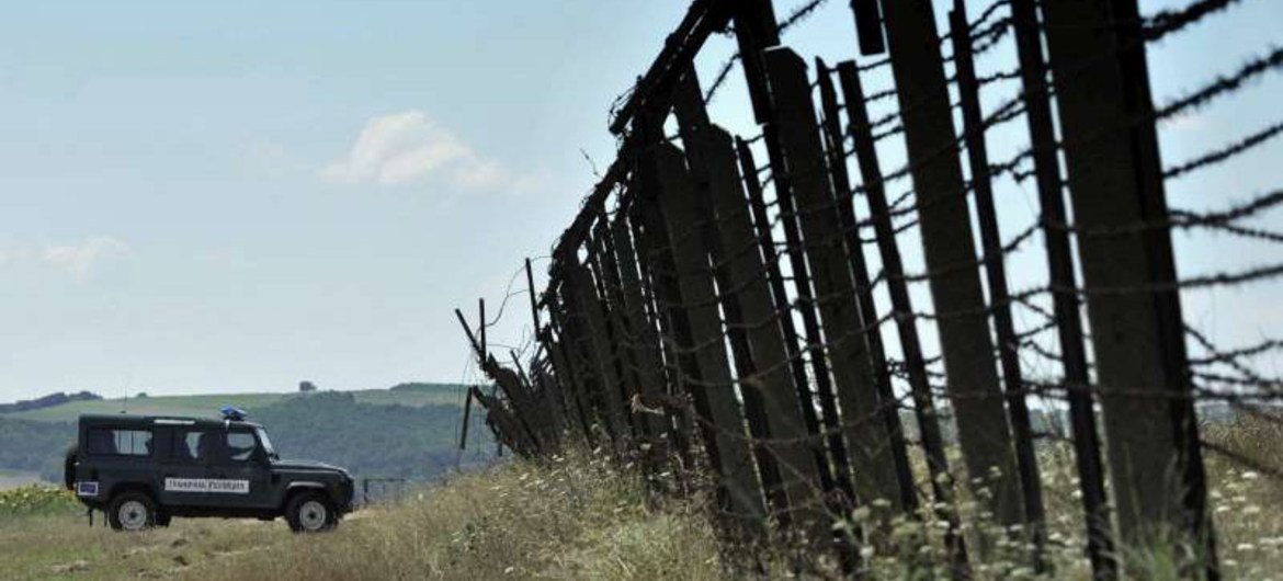 Bulgarian guards patrol a barbed wire fence of the Turkish border.