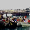The Djibouti coastguard escorts boats carrying refugees from Yemen into the port of Obock.