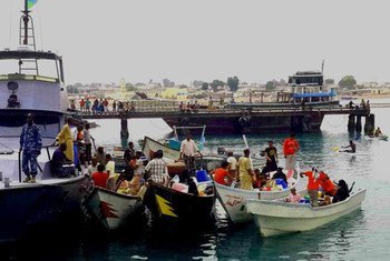 The Djibouti coastguard escorts boats carrying refugees from Yemen into the port of Obock.