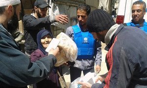 UNRWA distributes life-saving assistance to displaced civilians from Yarmouk in Yalda, Syria.