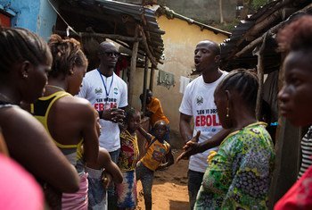 Social mobilizers going door-to-door, speak with residents of a slum in Freetown, the capital of Sierra Leone, in the fight against Ebola.