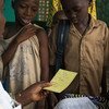 A nurse gives children their vaccination card after having received measles and polio vaccination, as well as deworming pills and Vitamin A supplement at the Madina Health Centre in Guéckédou, Guinea.