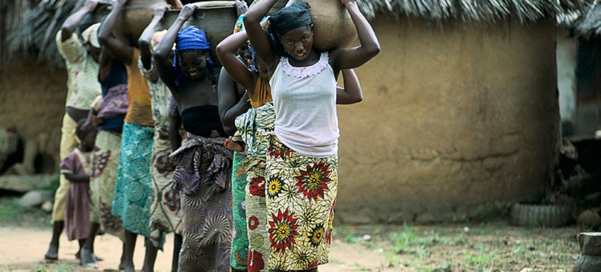 Young women and girls carry water in Nigeria (file photo).