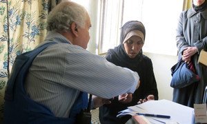 A woman receives medical treatment from an UNRWA doctor.