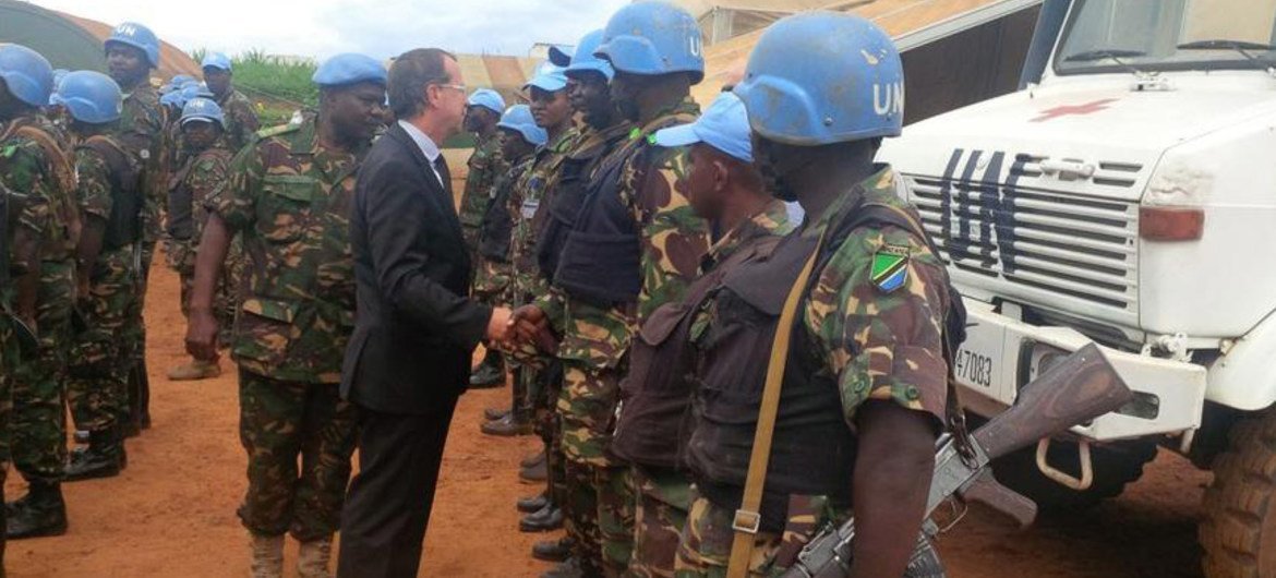 Martin Kobler, the Special Representative of the Secretary-General in the Democratic Republic of Congo (in suit) tells Tanzanian peacekeepers he strongly admires them despite the tragic loss of 2 comrades as they continue to actively protect the population.