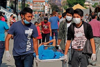 Patients at the Tribhuvan University Teaching Hospital, Kathmandu, Nepal, are taken outside following the second earthquake on 12 May 2015.