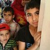 Children queue up at the UNRWA medical point in Yalda.