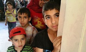 Children queue up at the UNRWA medical point in Yalda.
