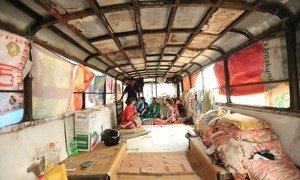 The interior of an old school bus, which, 14 people from two families in Nepal, have converted into temporary living quarters.