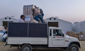 Volunteers load UNHCR relief supplies onto a truck at Tribhuvan International Airport in Kathmandu, Nepal. The aid will be distributed to affected areas across the country.