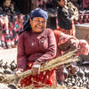 A woman in front of traditional pottery in Kathmandu's Durbar Square.