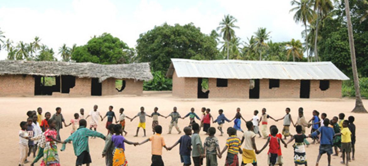 Children, holding hands to form a circle, play during recess at Mulemba Primary School in Zambezia Province, Mozambique.