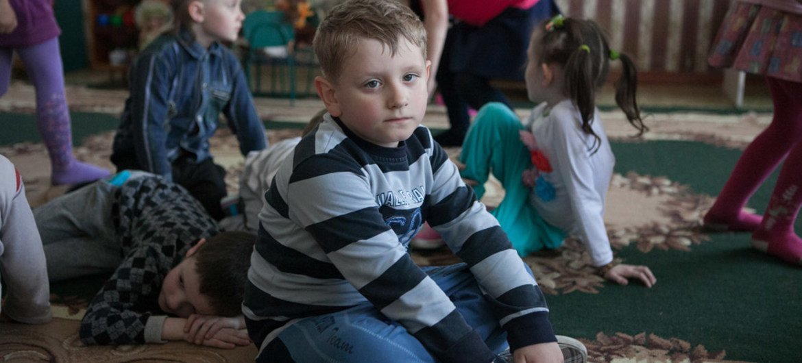 Children sit and lie on the floor while other children walk nearby, in a kindergarten in the city of Debaltseve, Donetsk Oblast (province), Ukraine.