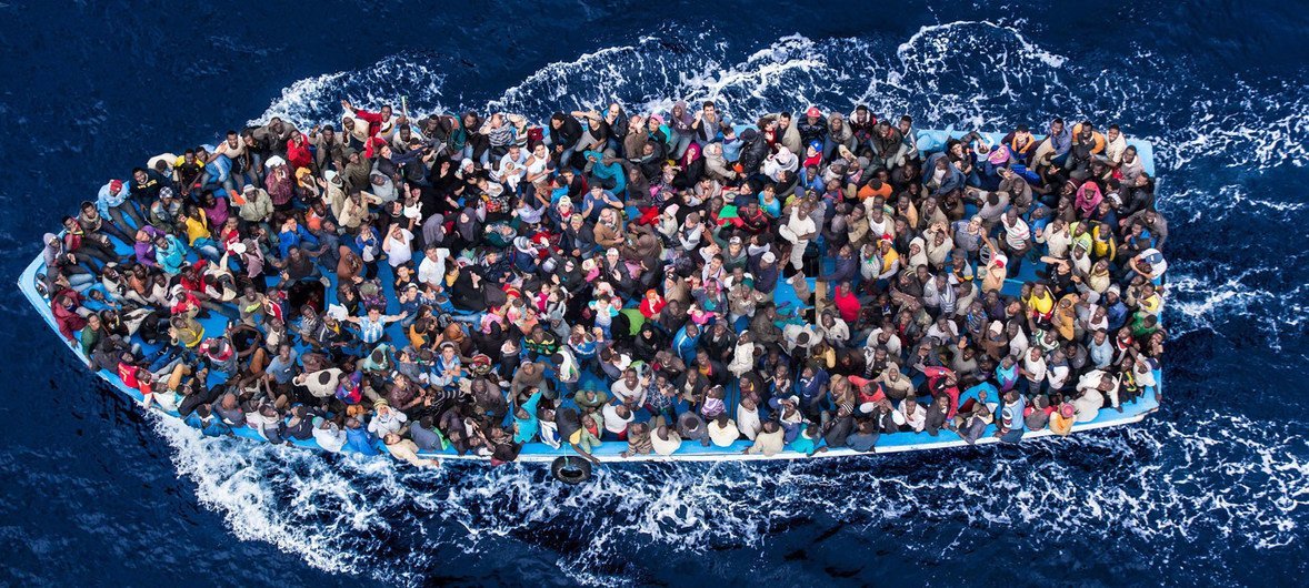 Hundreds of refugees and migrants aboard a fishing boat moments before being rescued by the Italian Navy as part of their Mare Nostrum operation in June 2014.
