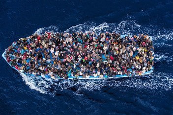 Hundreds of refugees and migrants aboard a fishing boat moments before being rescued by the Italian Navy as part of their Mare Nostrum operation in June 2014.