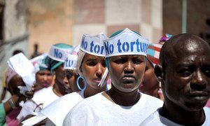 Singers wearing hats advocating “No Torture” line up before performing at a Human Rights Day event outside of Mogadishu Central Prison in Somalia on 10 December 2013.