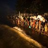 Burundian refugees, mostly women and children, wait on the shore of Lake Tanganyika to be transferred by boat to Kigoma and then on to Nyaragusu refugee camp.